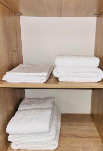 three towels on a shelf in a room at Downtown Studio 31 in Serres
