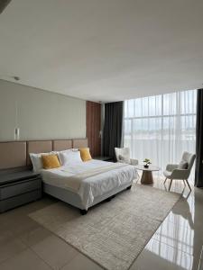 a bedroom with a large bed and a large window at The Legacy Hotel and Spa in Tzaneen +26 photos
