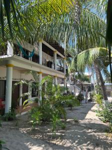 a building on the beach with palm trees at Terra Tipi in Guayabas