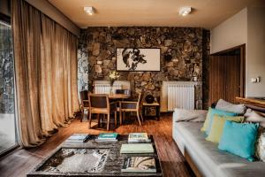 a living room with a couch and a table at Awasi Mendoza in Ciudad Lujan de Cuyo