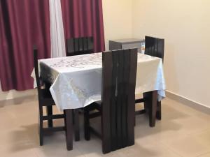 a table with a white table cloth on it at Ark House in Soroti +10 photos