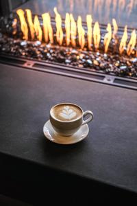 a cup of coffee sitting on a table next to a fireplace at Rayland Hotel in The Dalles