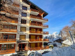 a building with snow in front of it at Nendaz Alpine Studio - Ski & Swimming Pool in Nendaz