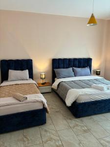 two beds sitting next to each other in a bedroom at Bejart Apartment 8 in Tirana