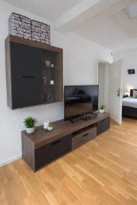 a living room with a large flat screen tv at Quartier An der Rennbahn in Bremen