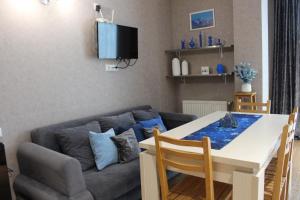 a living room with a table and a couch at Hotel Bobline 304 in Bakuriani