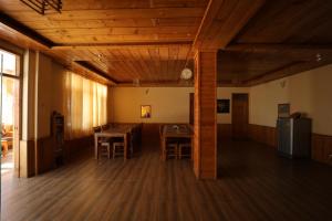 a room with a table and chairs and a clock at Village Crown in Mundaghat 