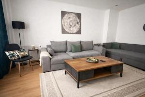 a living room with a couch and a coffee table at Apartman Cañas Zelená Víla in Rimavská Sobota