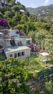a house on the side of a hill with a yard at Maison vue mer a 5 min de MONACO in Roquebrune-Cap-Martin