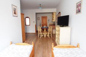 a room with two beds and a kitchen with a table at Apartmány Reve in Třeboň