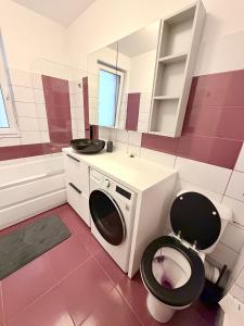 a bathroom with a toilet and a sink at FLH - Obralix Home in Sibiu