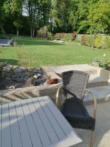 a chair and a table and a fire place at Studio Paisible in Nouzilly