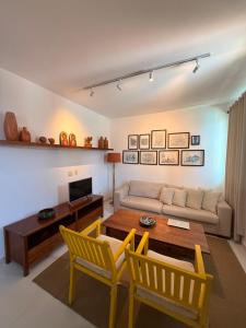 a living room with a couch and a table and chairs at Pousada Casa de Praia in Marechal Deodoro