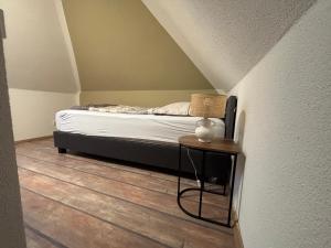 a small bed in a room with a table at Villa Blue Max in Großenhain