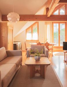 a living room with a couch and a table at Landhaus Alger in Immenstadt im Allgäu