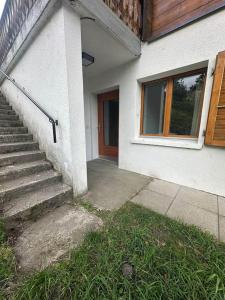 a house with a staircase leading to a door at Swiss Chalet - upstairs apartment in Grengiols +32 photos