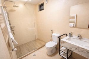 a bathroom with a toilet and a shower and a sink at Hotel Green Town in Kutaisi +70 photos