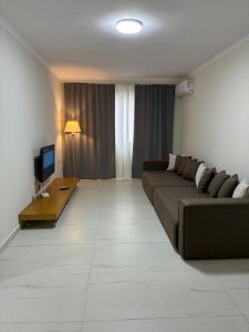 a living room with a couch and a television at Bejart Apartment 9 in Tirana