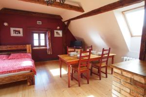 a bedroom with a bed and a table and chairs at Apartmány Reve in Třeboň