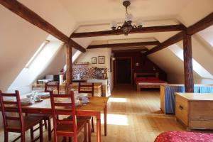 a dining room with a table and chairs at Apartmány Reve in Třeboň