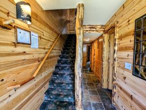 a staircase in a log cabin with wooden walls at Snow Summit Townhouse Unit 52 in Big Bear Lake