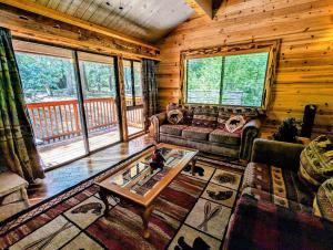 a living room with a couch and a table in a cabin at Snow Summit Townhouse Unit 52 in Big Bear Lake