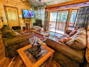 a living room with two couches and a tv at Snow Summit Townhouse Unit 52 in Big Bear Lake +32 photos