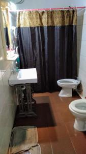 a bathroom with a black shower curtain and a toilet at Palermo Candombe House in Montevideo +67 photos