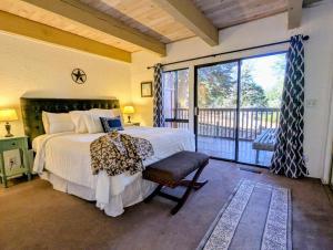 a bedroom with a large bed and a balcony at Snow Summit Townhouse Unit 09 in Big Bear Lake +6 photos