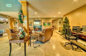a living room filled with furniture and a piano at Zanesville Inn in Zanesville