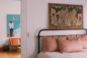 a bedroom with a painting above a bed with pillows at Object Hotel 1BR Room 3A in Bisbee