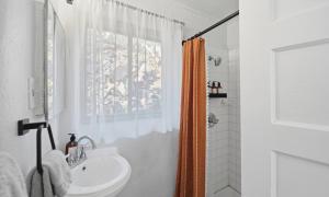 a white bathroom with a sink and a shower at Dam Site Lodging in Truth or Consequences +67 photos