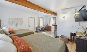 a hotel room with two beds and a flat screen tv at Dam Site Lodging in Truth or Consequences