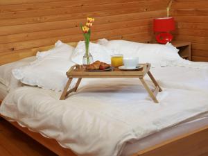 a tray of food on a table on a bed at Chata Sova Tále in Bystrá