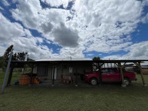 a red truck parked in front of a house at Cabañas Campestres Inés in Chillán