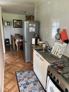 a kitchen with a stainless steel refrigerator and a sink at Cabañas Campestres Inés in Chillán +87 photos