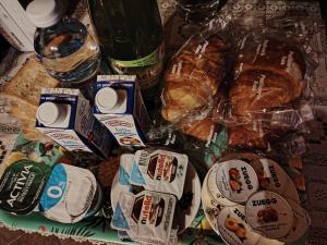 a table with a bunch of bread and bottles of water at Casa vacanza Da Lara in Poggio Ferrato +16 photos