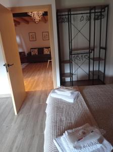 a room with a bed and a living room with a room at Casa Paulina in Beceite