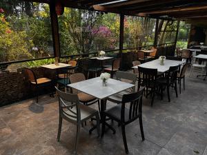 a group of tables and chairs on a patio at Skema Collections Quito in Quito