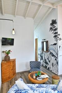 a living room with a couch and a table at Cottage Vanda in Le Moule