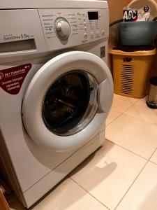 a washing machine with its door open in a kitchen at City Relax in Bălţi