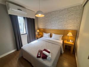 a hotel room with a bed with two towels on it at Hotel Aeroporto Congonhas com cozinha e sacada 1108 S in São Paulo +37 photos