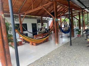 a hammock in a pavilion with a room at Cabañas Spacetatacoa in Villavieja