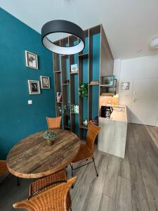a dining room with a wooden table and chairs at Nieznany Bór 8 in Hajnówka
