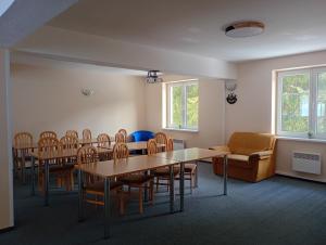 a room with tables and chairs and a couch at Horský Hotel Magura in Chvojnica