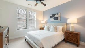 a bedroom with a white bed with two night stands and two lamps at Landing Modern 2BD Gym Pool in Cornelius +42 photos