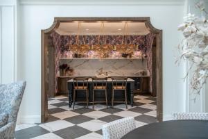 a dining room with a table and a checkered floor at Landing Modern 2BD Gym Pool in Cornelius