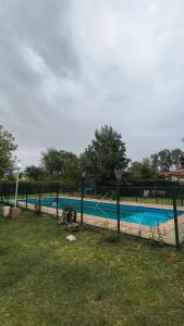 a fence in front of a swimming pool at La Angelica in Juana Koslay  +3 photos