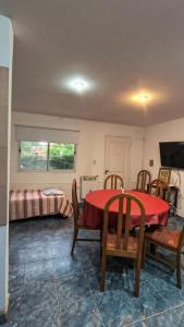 a room with a table and chairs and a bed at La Angelica in Juana Koslay 