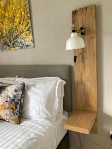 a bed with a lamp and a table next to it at Ceol na dTonnta in Doolin